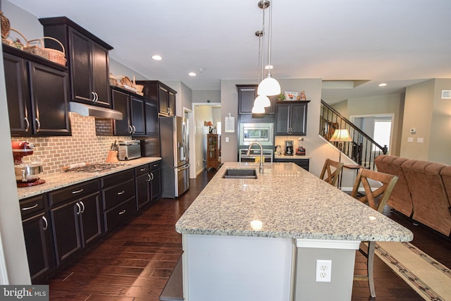 130 Steamboat Ct, North East, MD 21901 - kitchen with stainless steel appliances, a sink, dark wood-style flooring, a breakfast bar area, and decorative backsplash