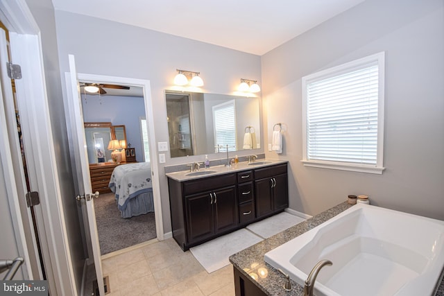 130 Steamboat Ct, North East, MD 21901 - bathroom with ensuite bath, double vanity, a garden tub, tile patterned flooring, and baseboards