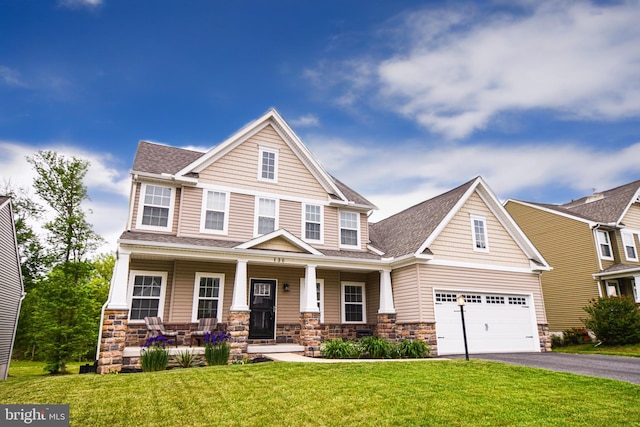 130 Steamboat Ct, North East, MD 21901 - craftsman inspired home featuring stone siding, asphalt driveway, covered porch, roof with shingles, and a front yard