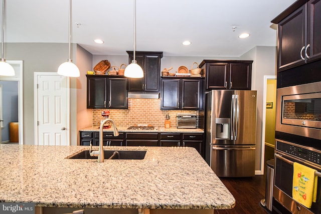 130 Steamboat Ct, North East, MD 21901 - kitchen with stainless steel appliances, a sink, dark wood finished floors, tasteful backsplash, and light stone counters