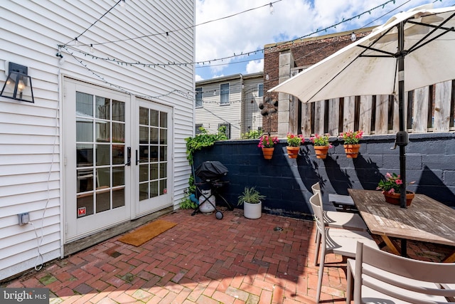view of patio / terrace featuring french doors and fence