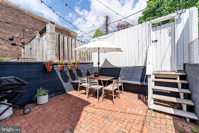 view of patio / terrace featuring fence and outdoor dining space
