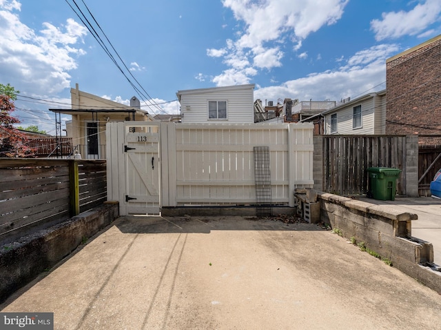 gate featuring fence and a patio