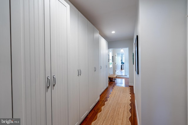 corridor featuring wood finished floors and recessed lighting
