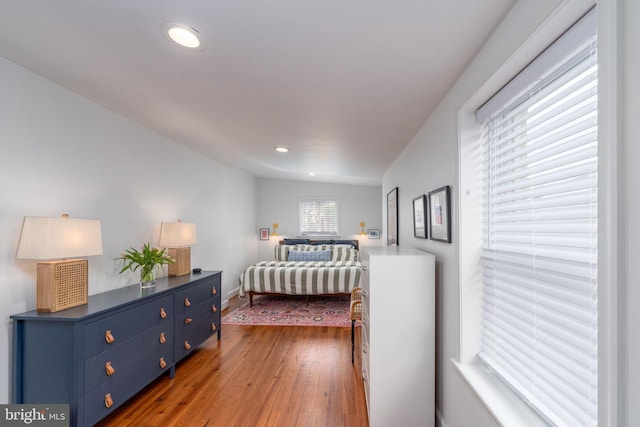 bedroom featuring hardwood / wood-style floors, recessed lighting, and baseboards