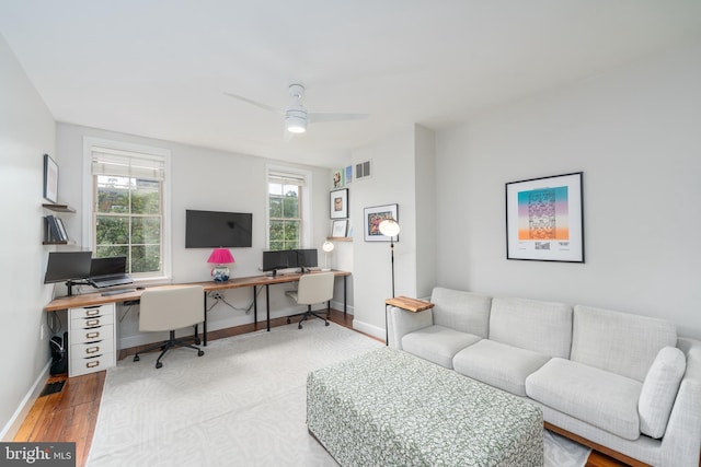 office with wood finished floors, a ceiling fan, and baseboards