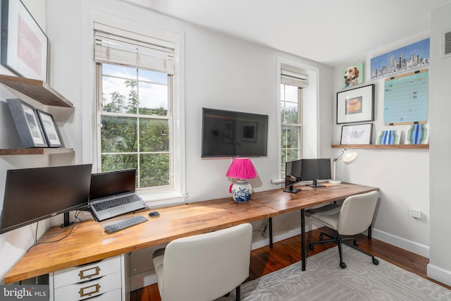 office area with wood finished floors, healthy amount of natural light, and baseboards