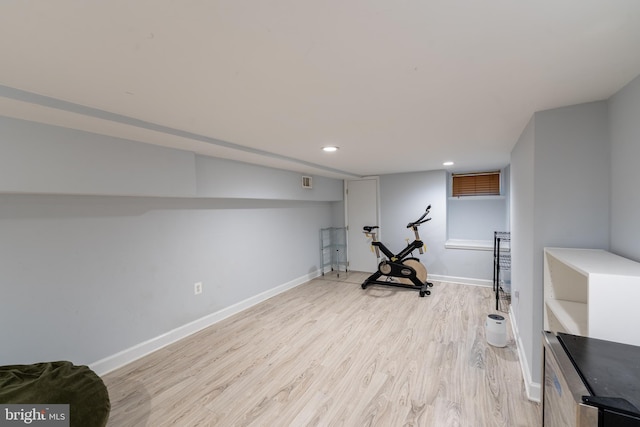 workout area featuring light wood finished floors, baseboards, and recessed lighting