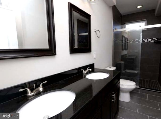 1248 N Hollywood St, Philadelphia, PA 19121 - bathroom featuring a stall shower, toilet, tile patterned flooring, and double vanity