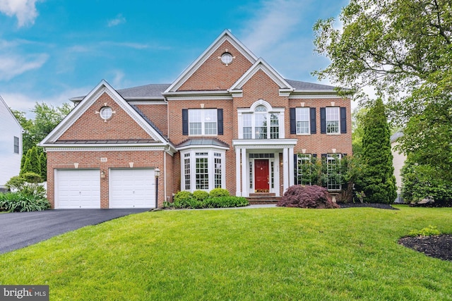 615 Pearl Point Ct, Millersville, MD 21108 - colonial-style house with asphalt driveway, brick siding, a front yard, and a garage