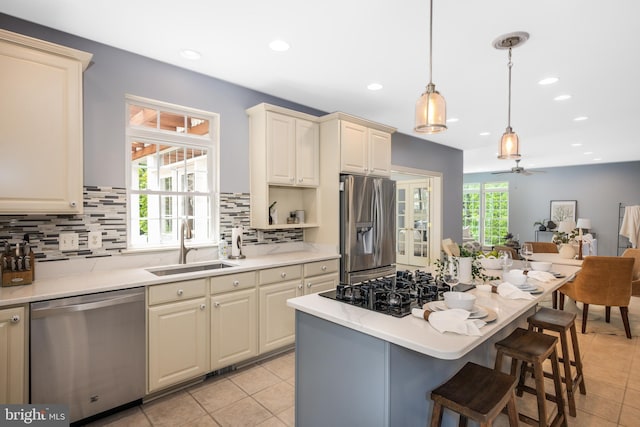 615 Pearl Point Ct, Millersville, MD 21108 - kitchen featuring stainless steel appliances, a sink, light tile patterned floors, backsplash, and light countertops