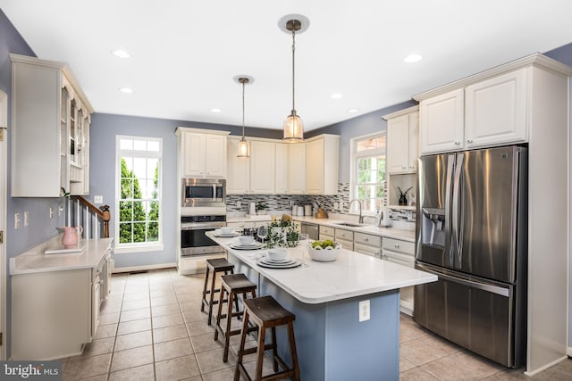 615 Pearl Point Ct, Millersville, MD 21108 - kitchen with stainless steel appliances, a sink, tasteful backsplash, a breakfast bar, and pendant lighting