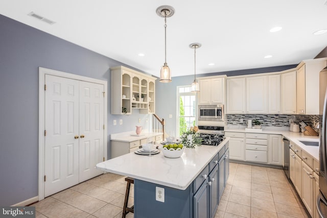 615 Pearl Point Ct, Millersville, MD 21108 - kitchen with stainless steel appliances, decorative backsplash, light tile patterned flooring, a breakfast bar area, and recessed lighting