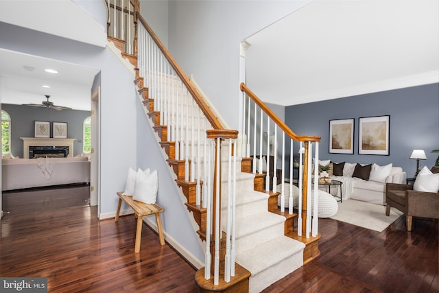 615 Pearl Point Ct, Millersville, MD 21108 - stairway with hardwood / wood-style flooring, a ceiling fan, a fireplace, recessed lighting, and baseboards