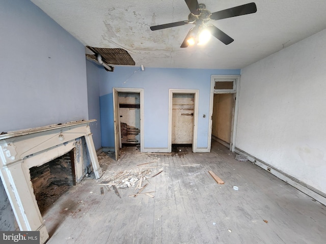unfurnished bedroom featuring two closets and ceiling fan