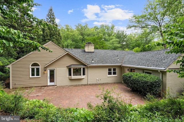 4009 30th St N, Arlington, VA 22207 - back of house with a chimney, a patio, brick siding, and roof with shingles