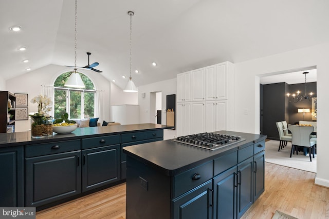 4009 30th St N, Arlington, VA 22207 - kitchen with dark countertops, stainless steel gas stovetop, a chandelier, vaulted ceiling, and a kitchen island