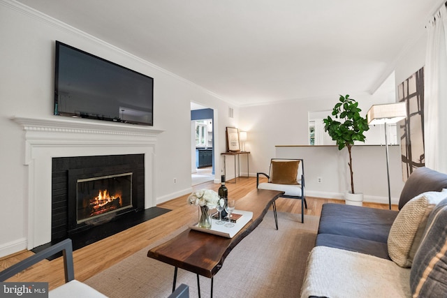 4009 30th St N, Arlington, VA 22207 - living area with ornamental molding, wood finished floors, a fireplace with flush hearth, and baseboards
