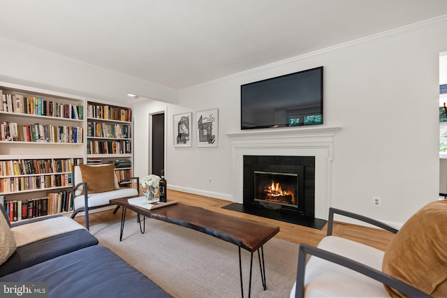 4009 30th St N, Arlington, VA 22207 - living room featuring wood finished floors, crown molding, a fireplace with flush hearth, and baseboards