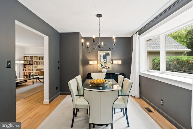 4009 30th St N, Arlington, VA 22207 - dining room featuring a chandelier, light wood-style floors, and baseboards