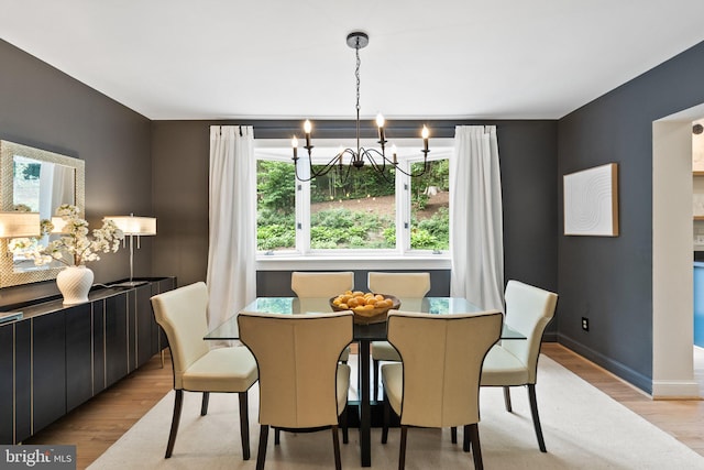 4009 30th St N, Arlington, VA 22207 - dining space featuring wood finished floors, a chandelier, and baseboards