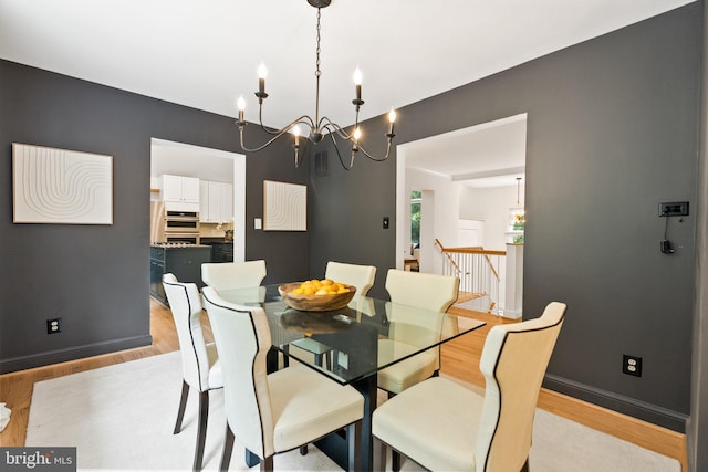 4009 30th St N, Arlington, VA 22207 - dining area with light wood-style floors, a chandelier, and baseboards