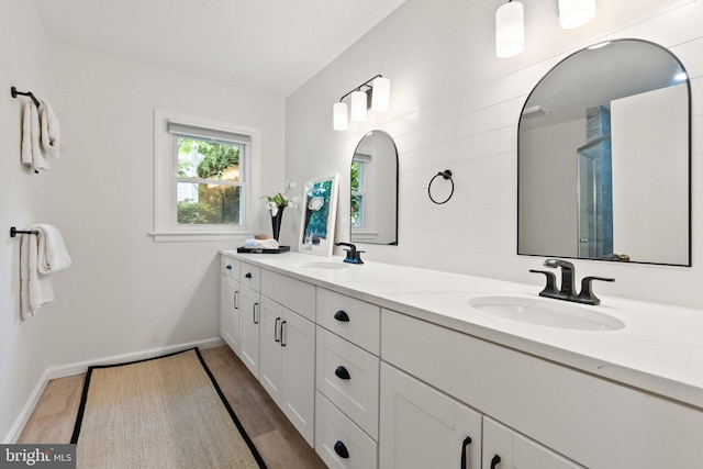 4009 30th St N, Arlington, VA 22207 - bathroom with wood finished floors, double vanity, and baseboards