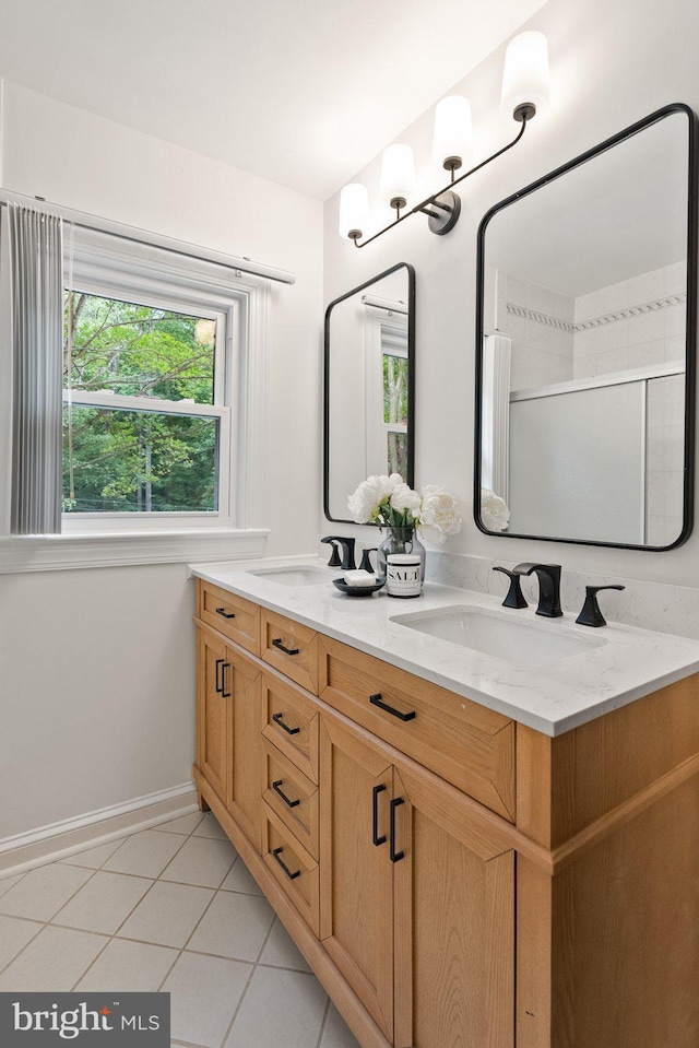 4009 30th St N, Arlington, VA 22207 - full bath featuring tile patterned floors, double vanity, and baseboards