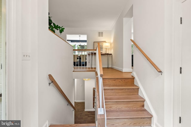 4009 30th St N, Arlington, VA 22207 - staircase with wood finished floors, crown molding, and baseboards