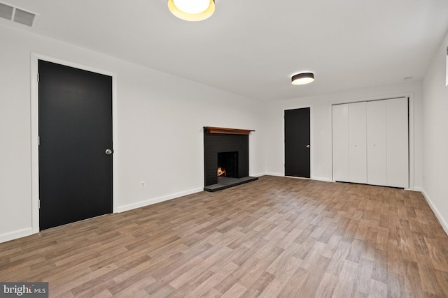 4009 30th St N, Arlington, VA 22207 - unfurnished living room with light wood-style flooring, a fireplace, and baseboards