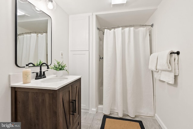 4009 30th St N, Arlington, VA 22207 - bathroom featuring vanity, a shower with shower curtain, and baseboards