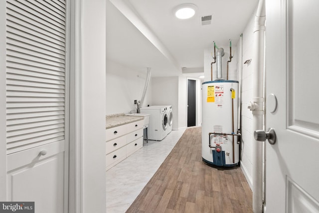 4009 30th St N, Arlington, VA 22207 - laundry room with water heater, washer and dryer, and light wood-style flooring