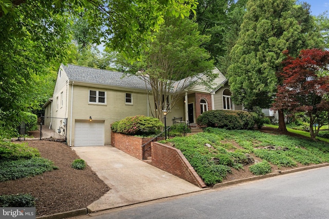 4009 30th St N, Arlington, VA 22207 - view of front of house featuring a garage, driveway, brick siding, and a shingled roof