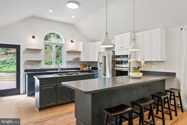 4009 30th St N, Arlington, VA 22207 - kitchen featuring stainless steel appliances, open shelves, a sink, vaulted ceiling, and white cabinetry