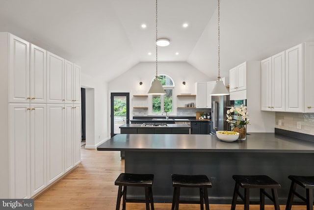 4009 30th St N, Arlington, VA 22207 - kitchen with dark countertops, open shelves, white cabinetry, tasteful backsplash, and vaulted ceiling