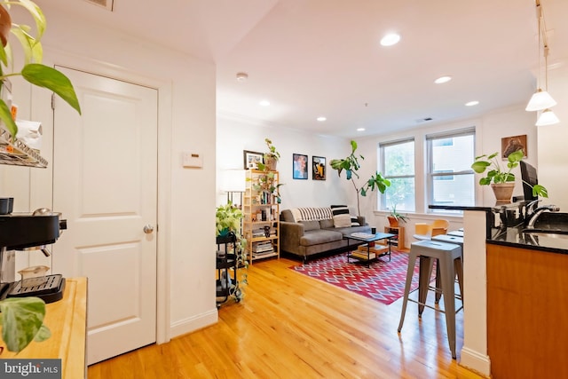 living room with light wood-style floors and recessed lighting