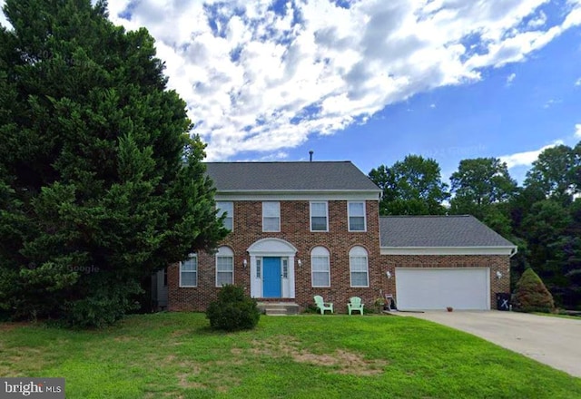 2452 Tuckahoe Ct, Waldorf, MD 20601 - view of front of home featuring an attached garage, driveway, a front yard, and brick siding