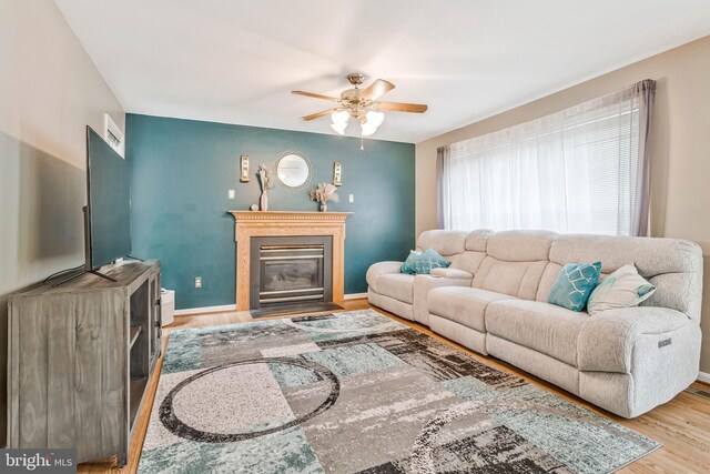 2452 Tuckahoe Ct, Waldorf, MD 20601 - living area with ceiling fan, wood finished floors, a glass covered fireplace, and baseboards