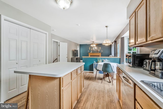 2452 Tuckahoe Ct, Waldorf, MD 20601 - kitchen featuring stainless steel dishwasher, light wood-style floors, light countertops, light brown cabinets, and a center island