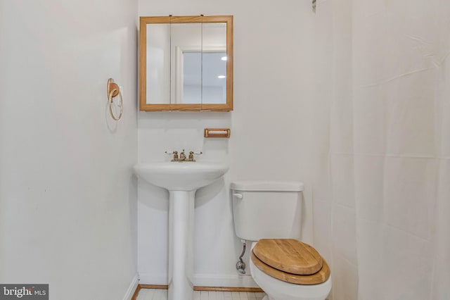 2452 Tuckahoe Ct, Waldorf, MD 20601 - half bathroom with toilet, baseboards, and a sink