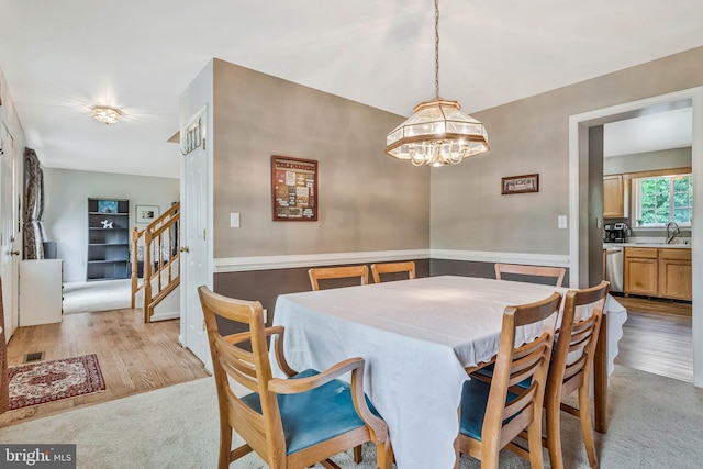 2452 Tuckahoe Ct, Waldorf, MD 20601 - dining room featuring light wood-style flooring, a chandelier, stairway, and baseboards