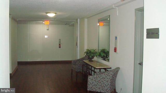 6641 Wakefield Dr Unit 801, Alexandria, VA 22307 - hall featuring a textured ceiling, wood finished floors, and baseboards