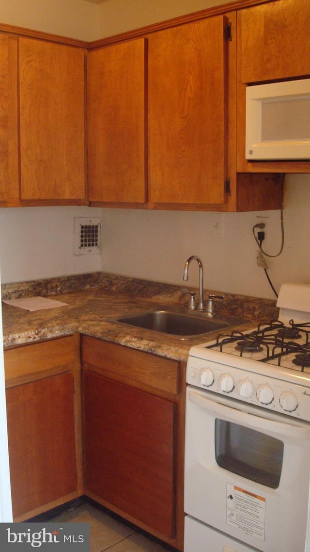 6641 Wakefield Dr Unit 801, Alexandria, VA 22307 - kitchen with white appliances, a sink, and brown cabinetry