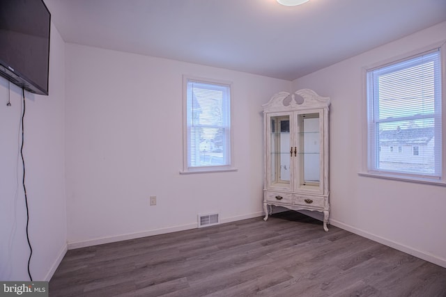 unfurnished bedroom featuring dark wood-style flooring and baseboards