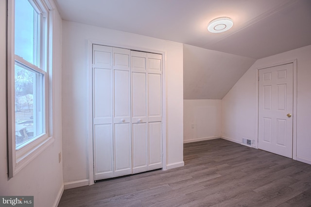 bonus room featuring wood finished floors, baseboards, and lofted ceiling
