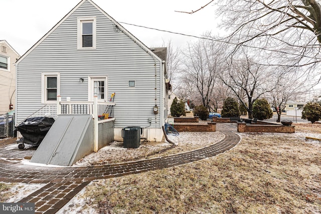rear view of property featuring central AC