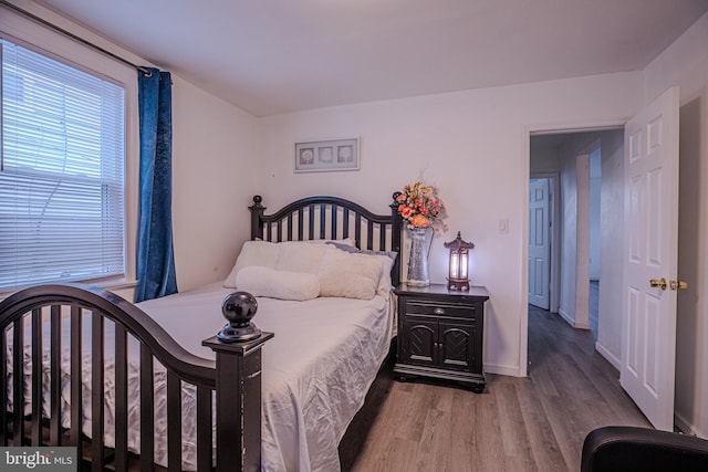 bedroom featuring wood finished floors and baseboards