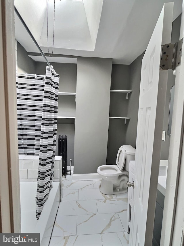 bathroom featuring marble look tile flooring, toilet, and shower / tub combo with curtain