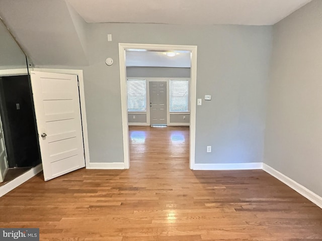 empty room featuring light wood finished floors and baseboards