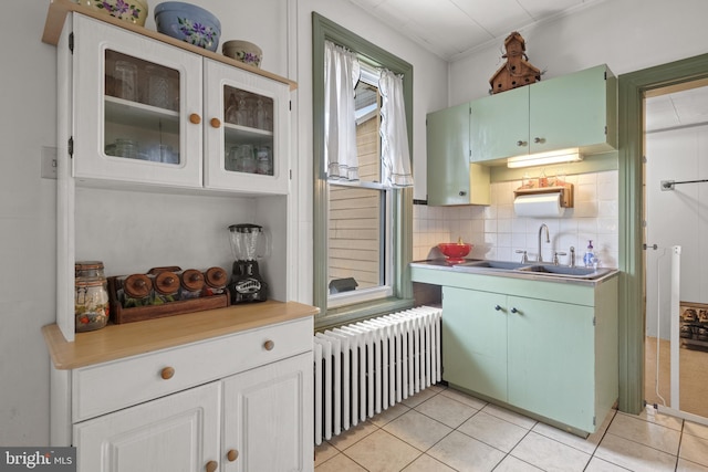 848 Houston St, Columbia, PA 17512 - kitchen featuring radiator heating unit, a sink, light tile patterned flooring, and light countertops